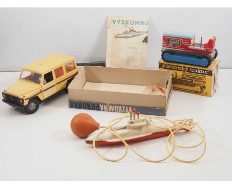 A group of vintage Czechoslovakian tinplate/plastic toy vehicles to include a remote controlled jeep (unboxed), a battery ope