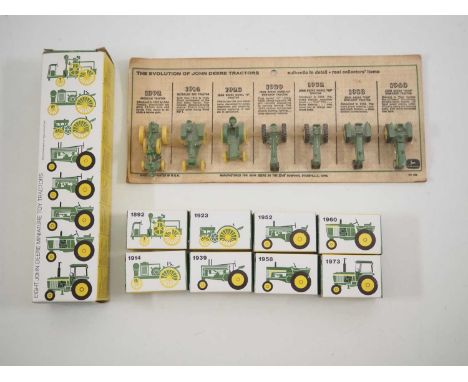 A pair of vintage ERTL 590 John Deere 'Evolution of Tractors' sets comprising a sealed display card version circa early 1960s