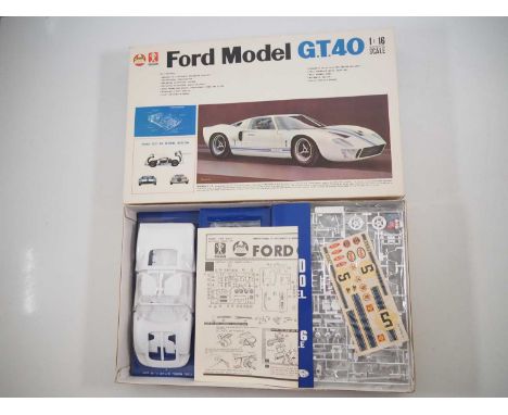 A BANDAI vintage unbuilt plastic 1:16 sale motorised model kit Ford Model GT40 no. K101-898, appears complete and unused. Mod