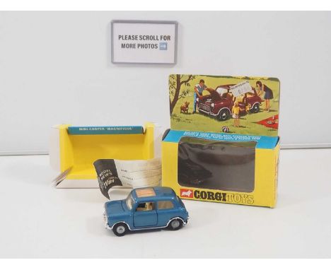 A CORGI 334 diecast Mini-Cooper 'Magnifique' in metallic blue with sliding striped sunroof blind, a couple of minor paint chi