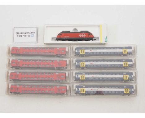 A TRIX N gauge Swiss outline Re460 class electric loco in SBB red livery together with a group of FLEISCHMANN Doppelstock dou