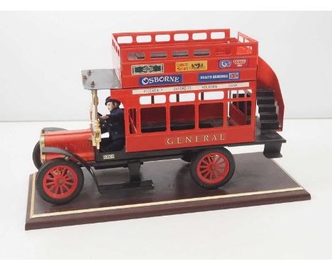 A GLORY DAYS large scale tinplate London General 'B' type style bus, with driver, mounted on wooden plinth - VG unboxed