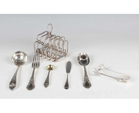 A late Victorian silver four-division toast rack with scroll divisions and loop handle, on ball feet, London 1900 by Charles 