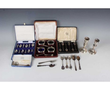 A set of four George V silver salts, each with a gadrooned and scallop shell rim, on scroll legs, and four matching salt spoo