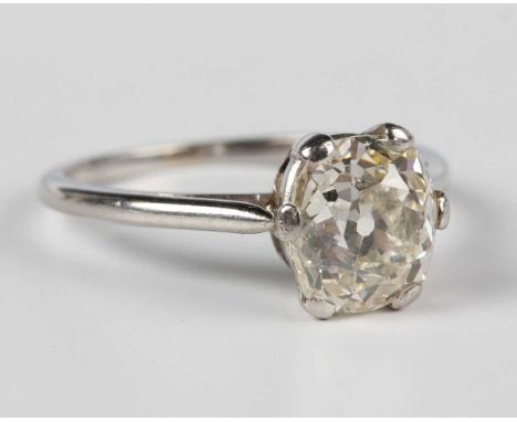 A platinum and diamond single stone ring, claw set with an oval cut cushion shaped diamond, detailed '991', weight 3.2g, diam