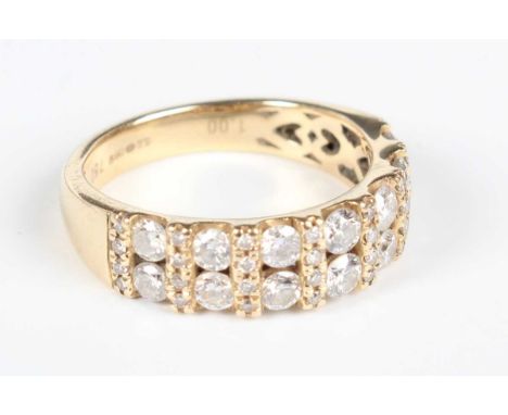 An 18ct gold and diamond ring, mounted with seven pairs of principal circular cut diamonds alternating with eight rows of fou