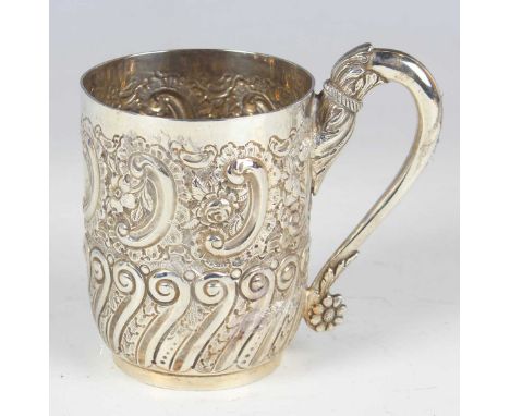 A late Victorian silver christening tankard of cylindrical form, chased with 'C' scrolls and flowers above a band of scrolls,