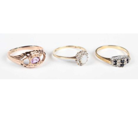 A 9ct gold ring, mounted with an oval cut amethyst with two pairs of diamond points, Birmingham 1918, ring size approx P (two