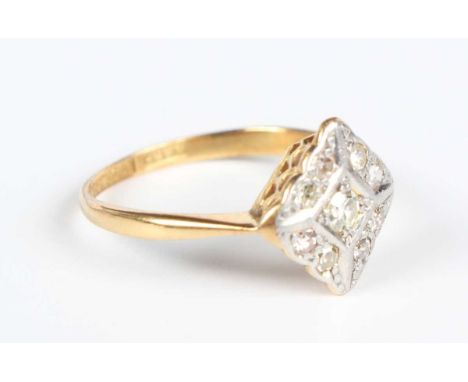 A gold, platinum and diamond lozenge shaped cluster ring, mounted with the principal circular cut diamond within a surround o