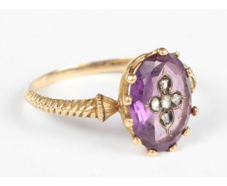 A gold, amethyst and diamond ring, last quarter of 19th century, the oval cut amethyst inset with five rose cut diamonds in a