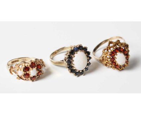 A 9ct gold, opal and sapphire oval cluster ring, ring size approx M1/2, a 9ct gold, opal and garnet oval cluster ring, ring s