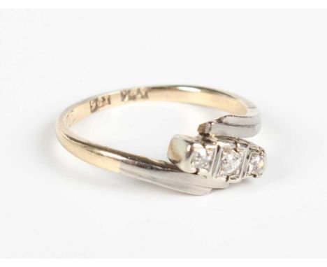 A gold, platinum and diamond three stone ring, mounted with cushion shaped diamonds in a crossover design, detailed ‘9ct PLAT