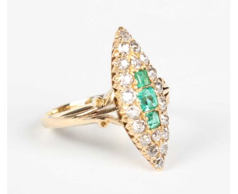 A gold, emerald and diamond marquise shaped cluster ring, mounted with three rectangular cut emeralds within a surround of cu