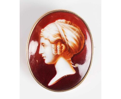 A gold mounted oval porcelain brooch, painted with a profile bust portrait of a classical lady, unmarked, width 3.5cm, length