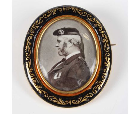 A Victorian gold and black enamelled oval mourning brooch relating to John Brown, a Scottish servant and favourite of Queen V