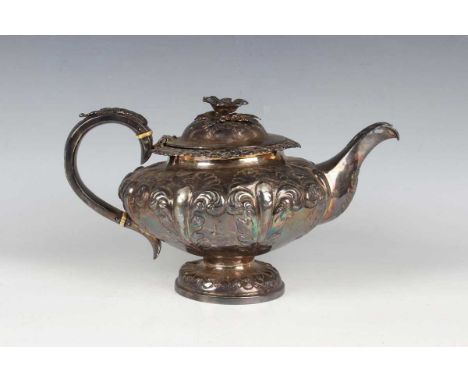 An early Victorian silver teapot of squat circular form, the hinged lid with flower finial above chased and engraved foliate 