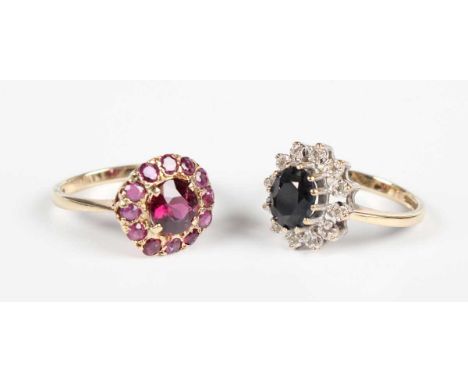 A 9ct gold and garnet cluster ring, claw set with the principal circular cut garnet at the centre, London 1966, ring size app