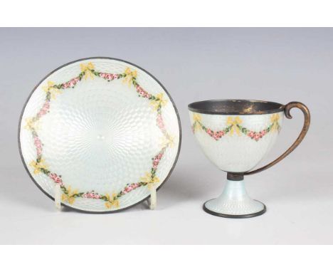 A Norwegian .930 sterling and enamelled cabinet cup and saucer, each painted with pink rose garlands and gilt ribbon bows aga