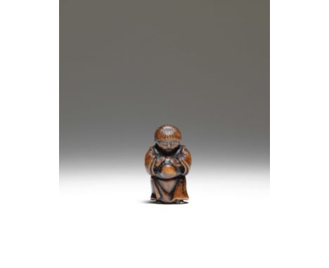 NETSUKE EN BOIS REPRESÉNTANT UN ENFANT TENANT UN MASQUEPar Masanao, Kyoto, fin du XVIIIe siècleA WOOD NETSUKE OF A CHILD HOLD