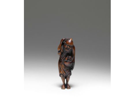NETSUKE EN BOIS REPRÉSENTANT CHINNAN SENNIN AVEC UN DRAGON DANS UN BOLFin du XVIIIe/début XIXe siècle A WOOD NETSUKE OF CHINN
