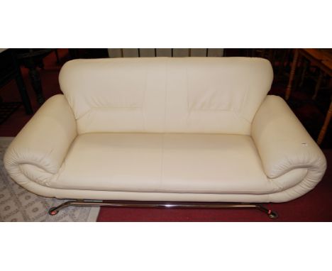 A modern cream leatherette upholstered two-seater sofa in the style of Le Courbusier, on chrome base 