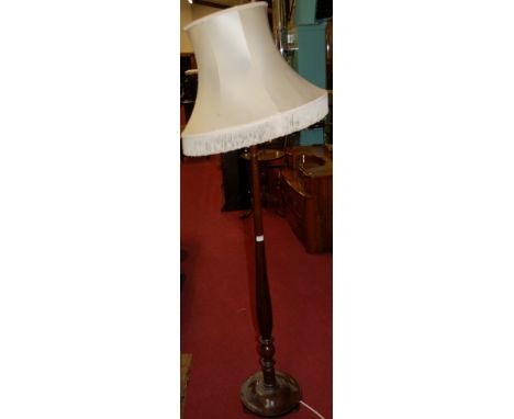 An early 20th century turned mahogany standard lamp and shade
