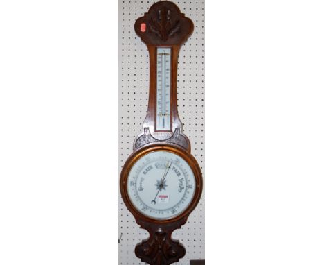 An early 20th century oak cased aneroid barometer 