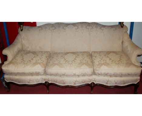 An early 20th century walnut framed and floral damask upholstered scroll-end three seater sofa 