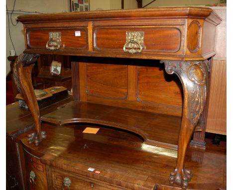 An early 20th century walnut side table, the rectangular top with canted angles on carved cabriole supports and paw feet, sta