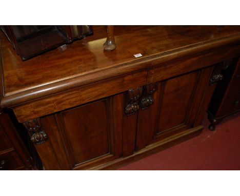 A Victorian mahogany sideboard having two cushion frieze drawers with cupboards below on plinth base