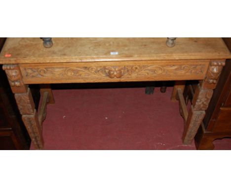 A late Victorian carved oak side table having a single drawer with lion mask handle