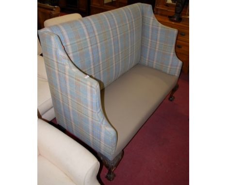 An early 20th century highback two seater sofa on carved cabriole supports and claw and ball feet 