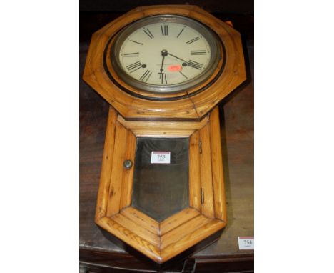 A late 19th century pine cased American drop trunk wall clock, the dial signed Seth Thomas