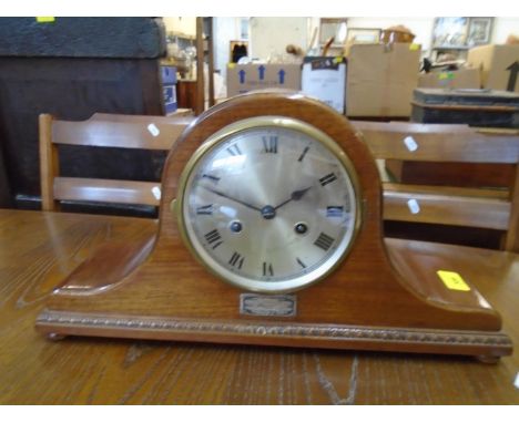 A 1930s walnut cased Napoleon Hat mantle clock, silvered Roman dial with white metal presentation mount below dated 1936, the