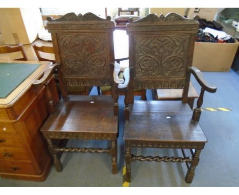 A pair of 19th century oak baronial style carver chairs, scroll carved crest rail, carved panel back in the Tudor style, with