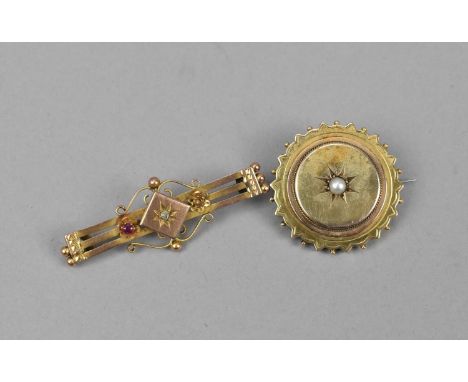 A 9ct gold Edwardian bar brooch, inset with a central old cut diamond and flanked with a ruby to one side, the other gemstone