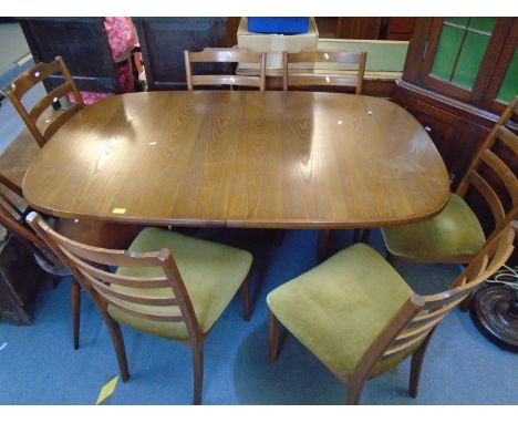 A G-Plan extending dining table with raising extra leaf, and six G-Plan chairs with ladder backs and green upholstered seats,