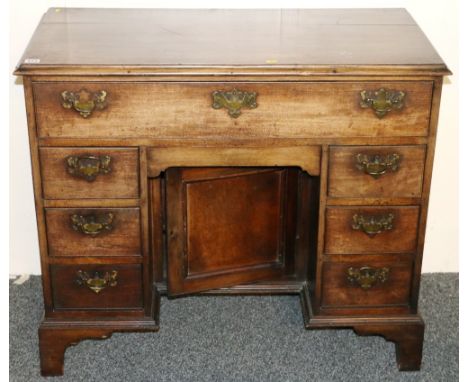 George III mahogany kneehole dressing table, with central cupboard and eight drawers raised on bracket feet, 81cm x 95cm.   C