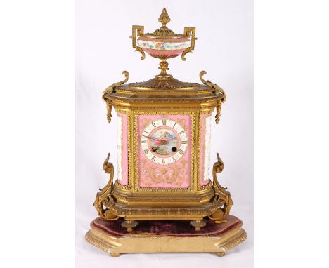 19th century French gilt porcelain ormolu mantel clock, the pink ground panels decorated with gallants and floral sprays, the