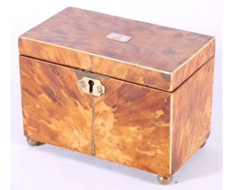 Georgian tortoiseshell tea caddy of rectangular form, inlaid ivory and white metal stringing, white metal crested panel brass