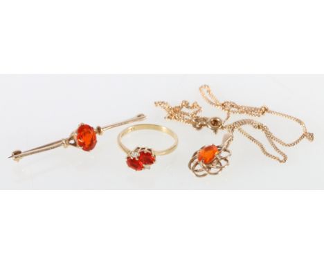 9ct gold orange stone possibly sesspartite garnet or fire opal suite comprising ring, pendant on chain and bar brooch.