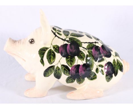 Griselda Hill pottery model of a pig decorated with plums, painted green signature to base, 41cm.   CONDITION REPORT:  Face i