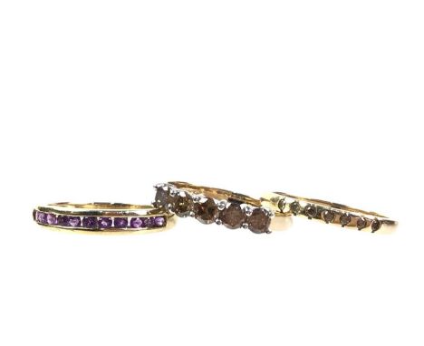 TWO DIAMOND RINGS AND A DRESS STONE RING, IN NINE CARAT GOLD comprising a diamond chip ring, a five stone champagne diamond r