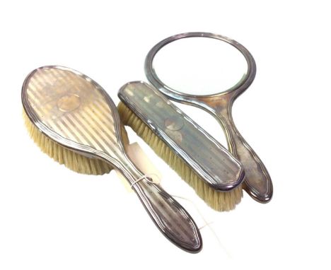 GEORGE V SILVER VANITY SET, BIRMINGHAM MARKS  comprising a hand mirror and two brushes, with engine turned decoration, along 