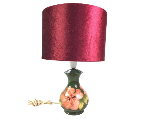 MOORCROFT TABLE LAMP, with tube lined floral decoration on a green ground, with red shade38cm high overallScratches, genera, 