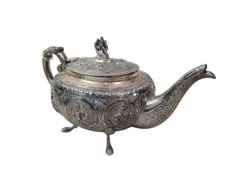 INDO-TIBETAN WHITE METAL THREE PIECE TEA SERVICE, comprising teapot, sugar bowl and cream jug