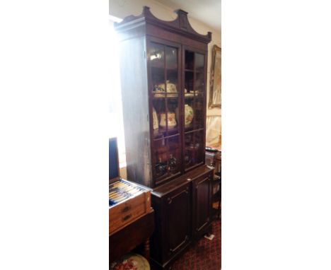 Georgian mahogany bookcase, having two door glazed upper section above two cupboard doors, standing on bracket feet