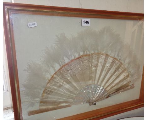 Embroidered antique silk and feather fan with mother-of-pearl sticks and guards, mounted in wall display case