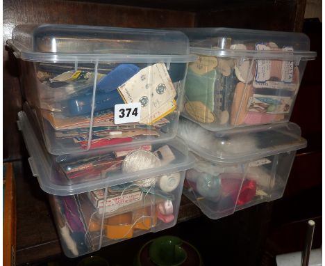 Four boxes containing assorted vintage sewing items and accessories