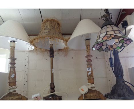 Pair of painted wood table lamps, another and a desk lamp with metal base having Tiffany style lamp shade